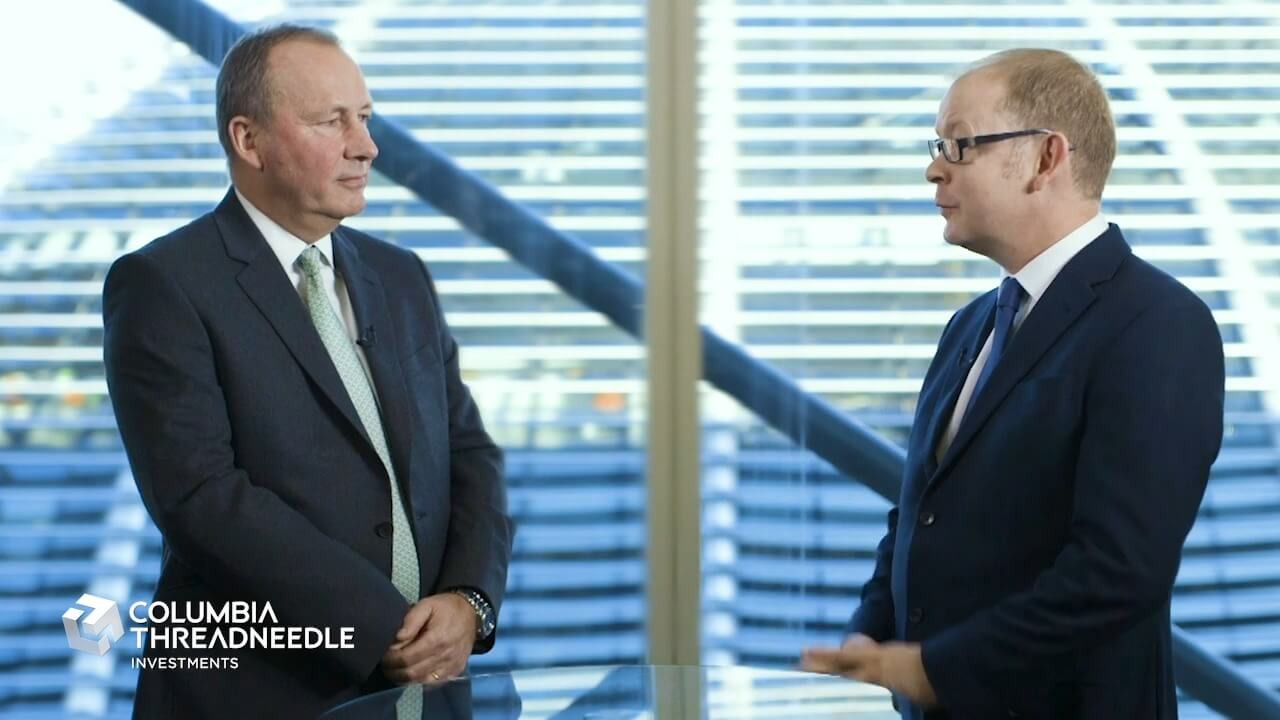 Two men in suits are talking